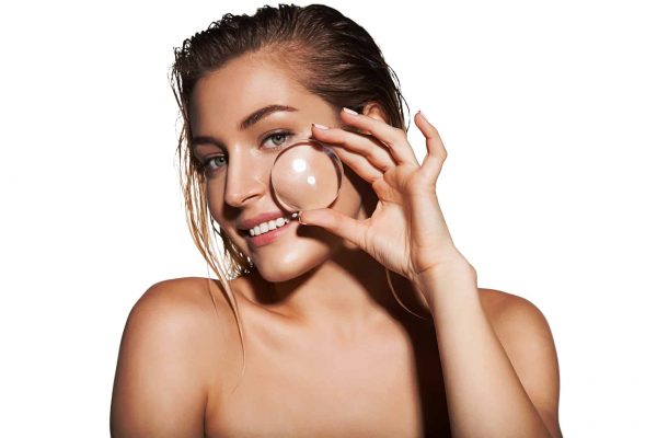 Beautiful woman with magnifier near her face